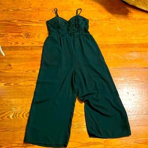 Emerald green romper with velvet detailing